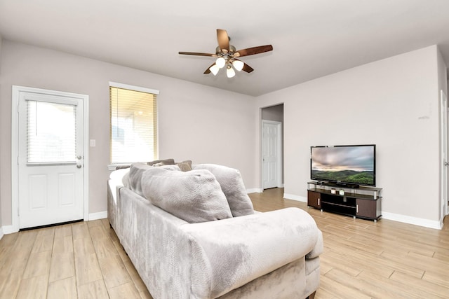 living room featuring light wood-type flooring and ceiling fan