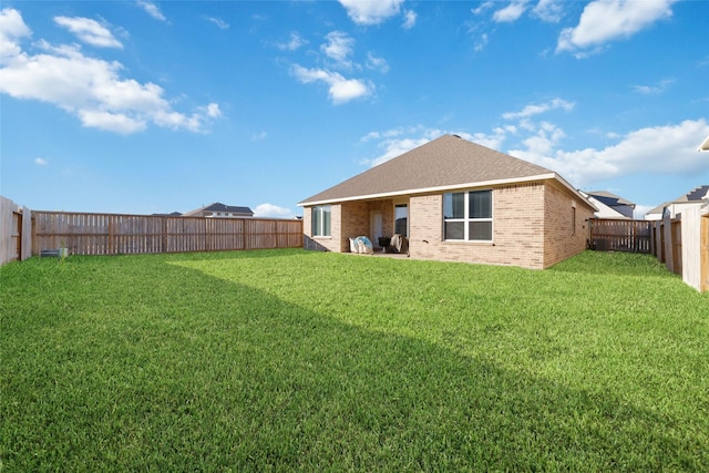 rear view of house with a lawn