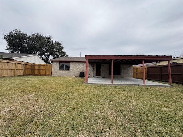 back of property featuring a patio, a yard, and central AC