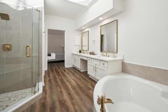 bathroom with hardwood / wood-style flooring, vanity, and independent shower and bath