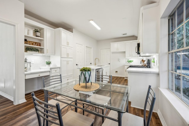 dining room with dark hardwood / wood-style flooring and sink