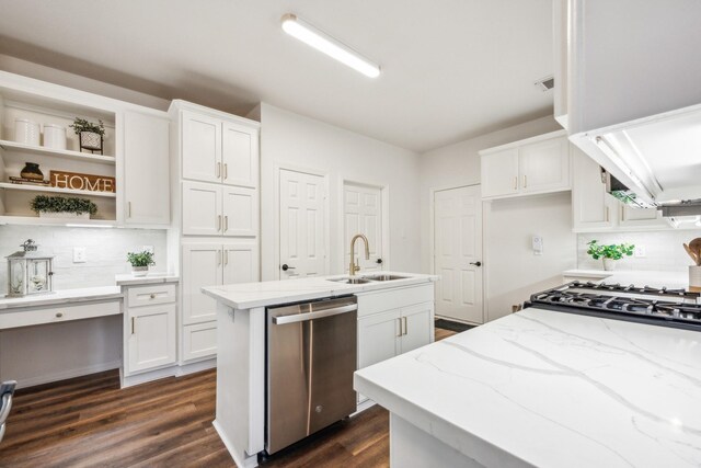 kitchen with sink, white cabinetry, built in desk, dishwasher, and a kitchen island with sink