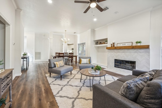 living room featuring hardwood / wood-style flooring, a tile fireplace, and ornamental molding