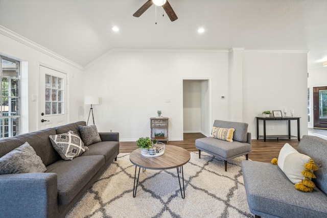 living room featuring ceiling fan, vaulted ceiling, ornamental molding, and wood-type flooring