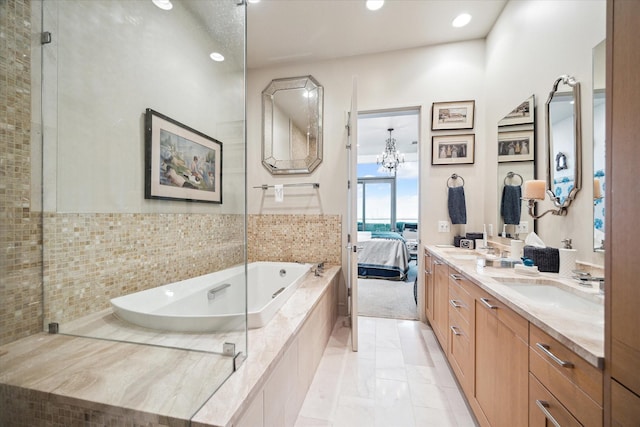 2727 Kirby Dr Unit 13C, Houston, TX 77098 - bathroom with tiled bath, vanity, and a chandelier