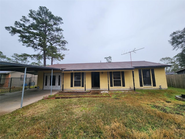 ranch-style home with a front lawn and a carport