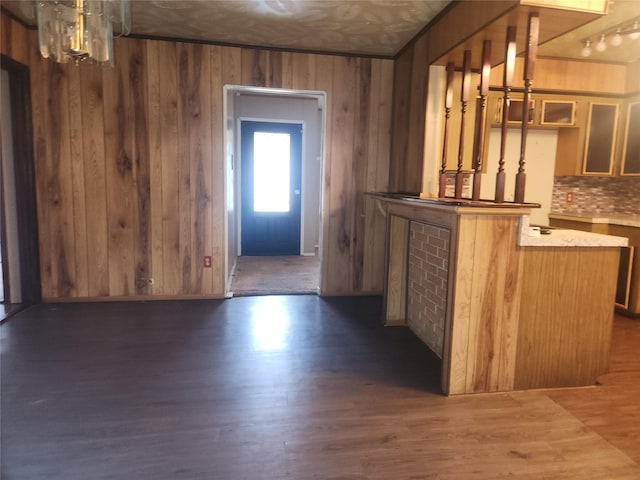 interior space featuring dark hardwood / wood-style floors and wooden walls