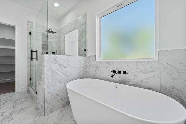 bathroom featuring separate shower and tub