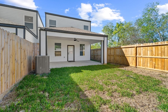 rear view of house featuring ceiling fan, a patio area, central AC, and a lawn