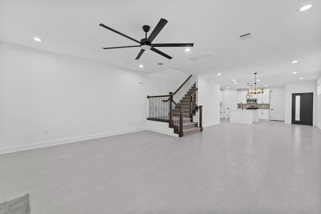 unfurnished living room with light tile patterned floors and ceiling fan with notable chandelier