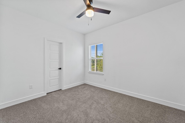 carpeted spare room featuring ceiling fan