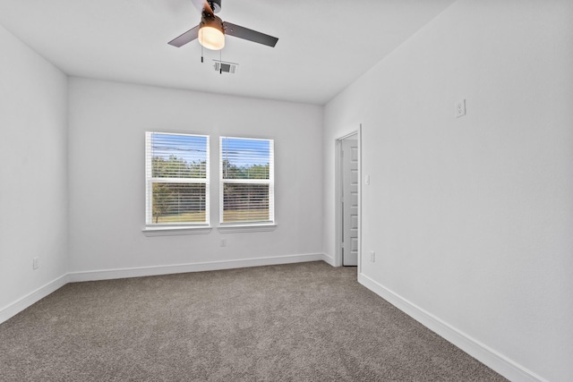 spare room with ceiling fan and carpet