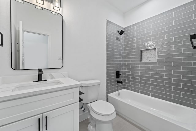 full bathroom featuring toilet, tiled shower / bath combo, tile patterned floors, and vanity