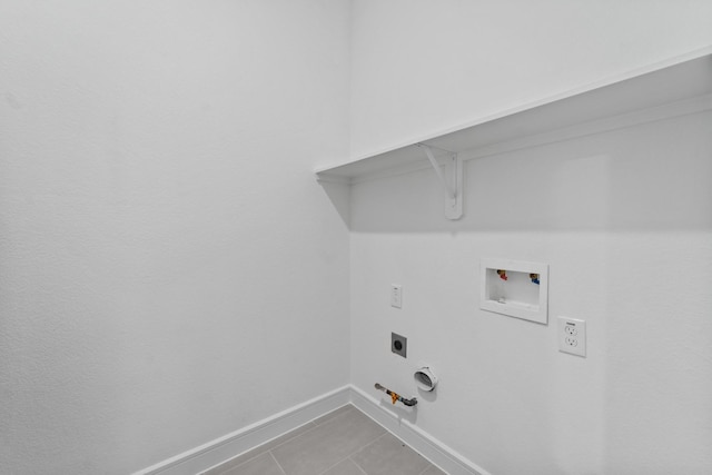 washroom with washer hookup, light tile patterned floors, hookup for an electric dryer, and hookup for a gas dryer