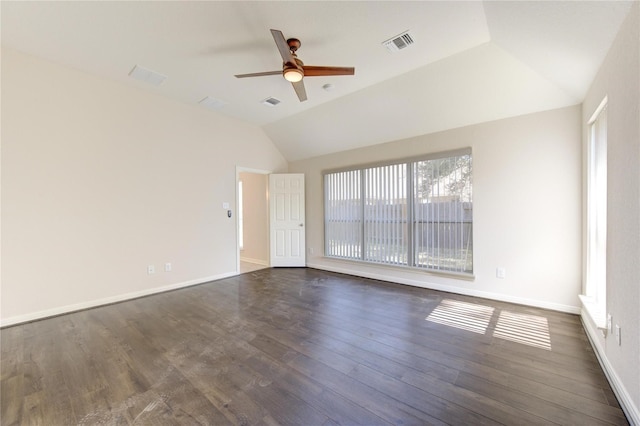 empty room with ceiling fan, dark hardwood / wood-style flooring, and vaulted ceiling