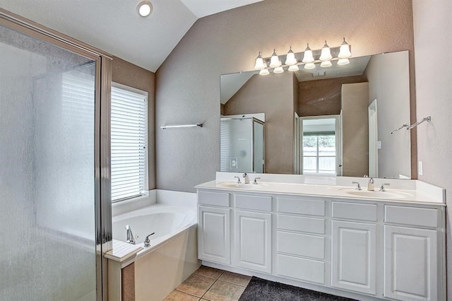 bathroom featuring vaulted ceiling, vanity, separate shower and tub, and tile patterned flooring