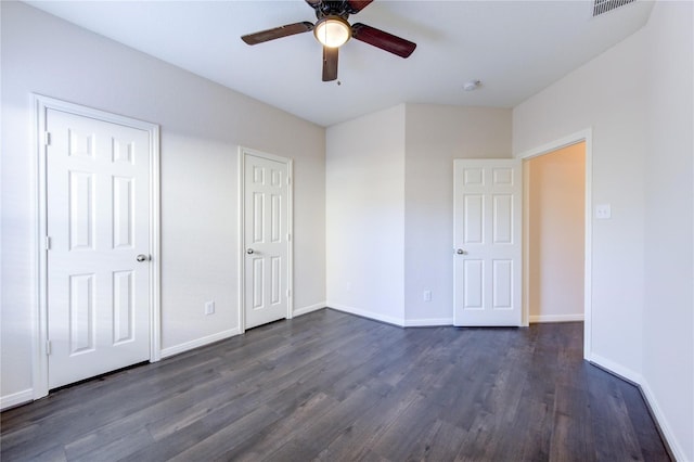 unfurnished bedroom featuring ceiling fan and dark hardwood / wood-style flooring