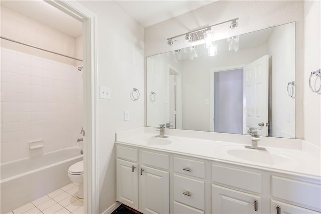 full bathroom with tile patterned flooring, vanity, tiled shower / bath combo, and toilet