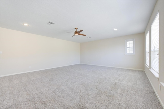 carpeted empty room featuring ceiling fan