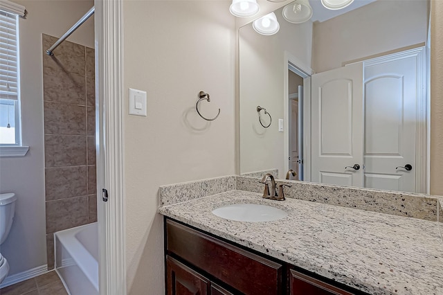 full bathroom with tiled shower / bath combo, vanity, tile patterned floors, and toilet