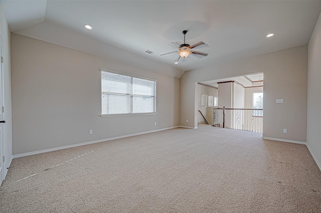 carpeted spare room featuring ceiling fan