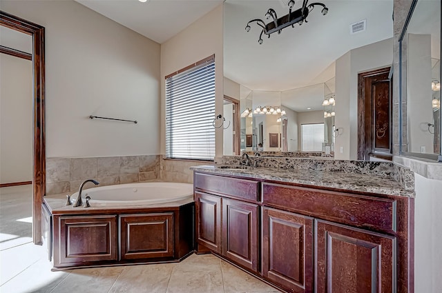 bathroom featuring vanity and a tub to relax in