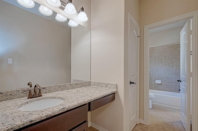 full bathroom featuring vanity, tiled shower / bath, tile patterned floors, and toilet