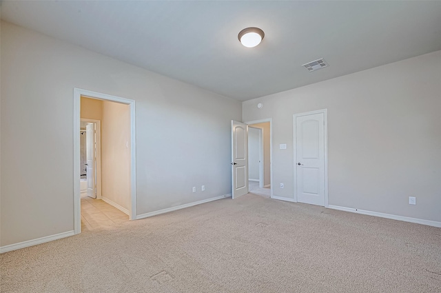 unfurnished bedroom featuring light carpet