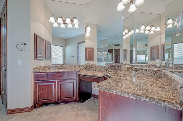 bathroom with a shower with door, vanity, and tile patterned flooring