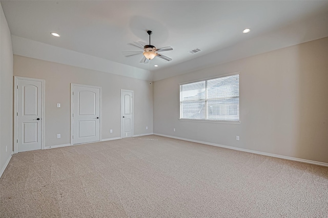 empty room with ceiling fan and carpet floors