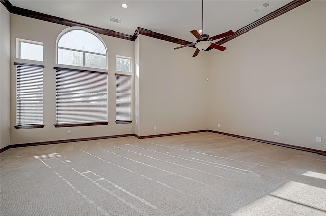 unfurnished room featuring ceiling fan, ornamental molding, and light carpet