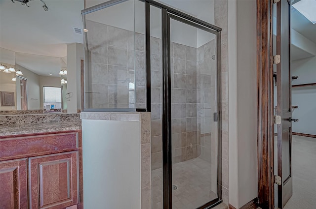 bathroom with vanity and a shower with shower door