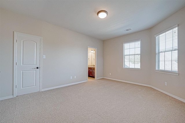 empty room featuring light carpet