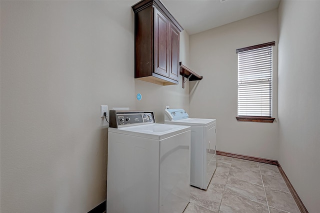 laundry room with cabinets and washer and clothes dryer