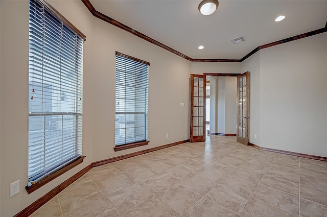 spare room featuring crown molding and french doors