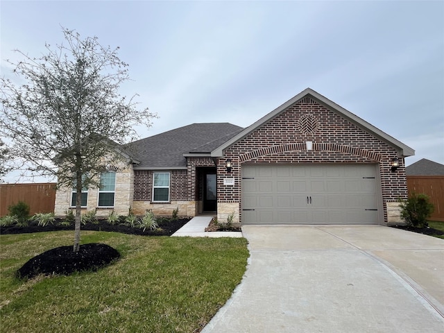 view of front of home with a front yard and a garage