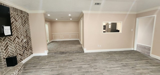 empty room featuring crown molding