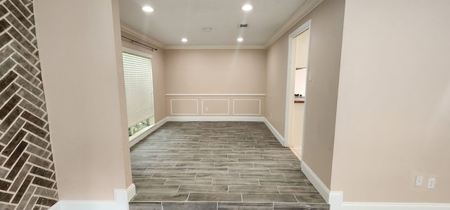 hall featuring crown molding and hardwood / wood-style flooring