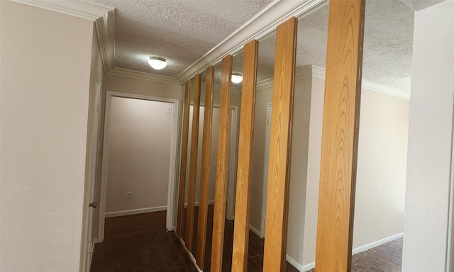 hall featuring a textured ceiling and ornamental molding