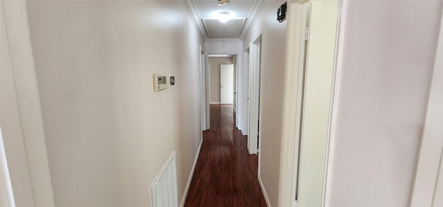 hall with ornamental molding and dark hardwood / wood-style floors