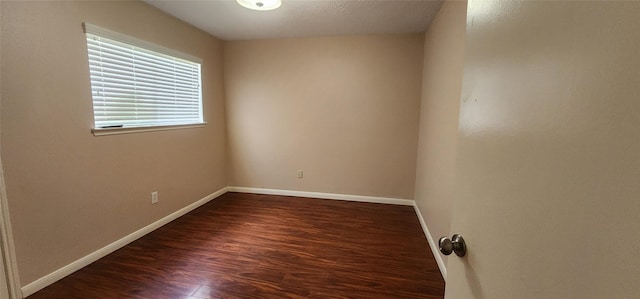 unfurnished room featuring dark hardwood / wood-style flooring