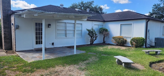 rear view of house featuring central AC unit, a pergola, a patio area, and a yard