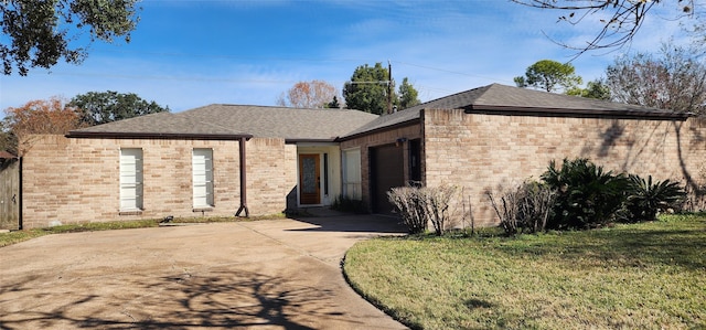 rear view of property with a garage and a yard