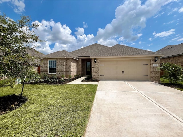 view of front of home with a front lawn and a garage