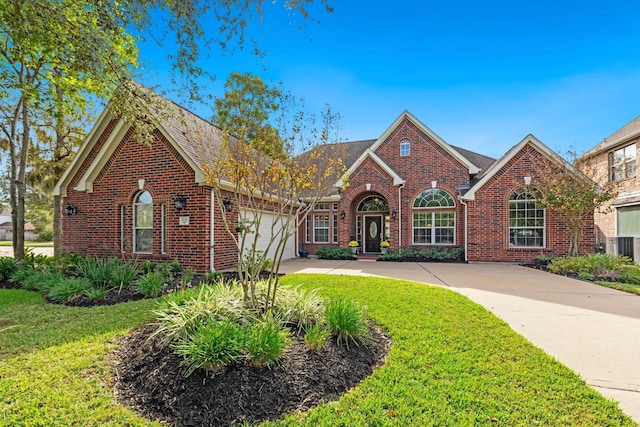 view of front of property featuring a garage and a front yard