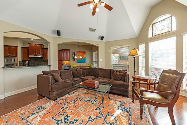 living room with ceiling fan, light wood-type flooring, vaulted ceiling, and sink