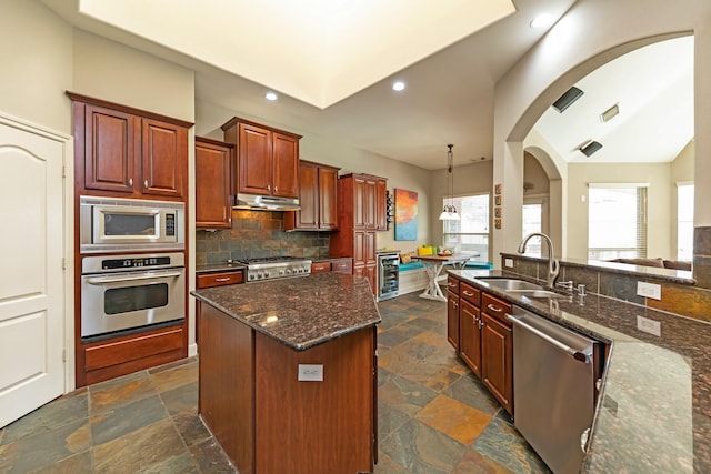 kitchen with wine cooler, dark stone countertops, a kitchen island, sink, and stainless steel appliances