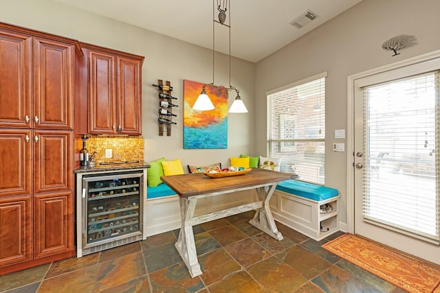 dining room featuring beverage cooler and breakfast area