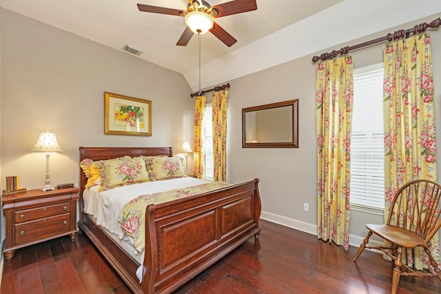 bedroom with ceiling fan, vaulted ceiling, dark hardwood / wood-style flooring, and multiple windows