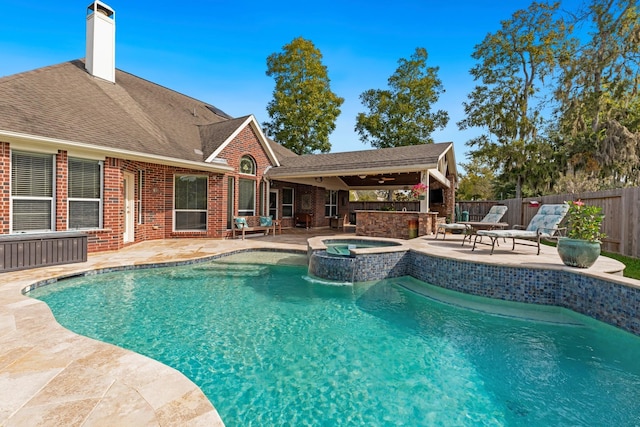 view of swimming pool featuring a patio and an in ground hot tub